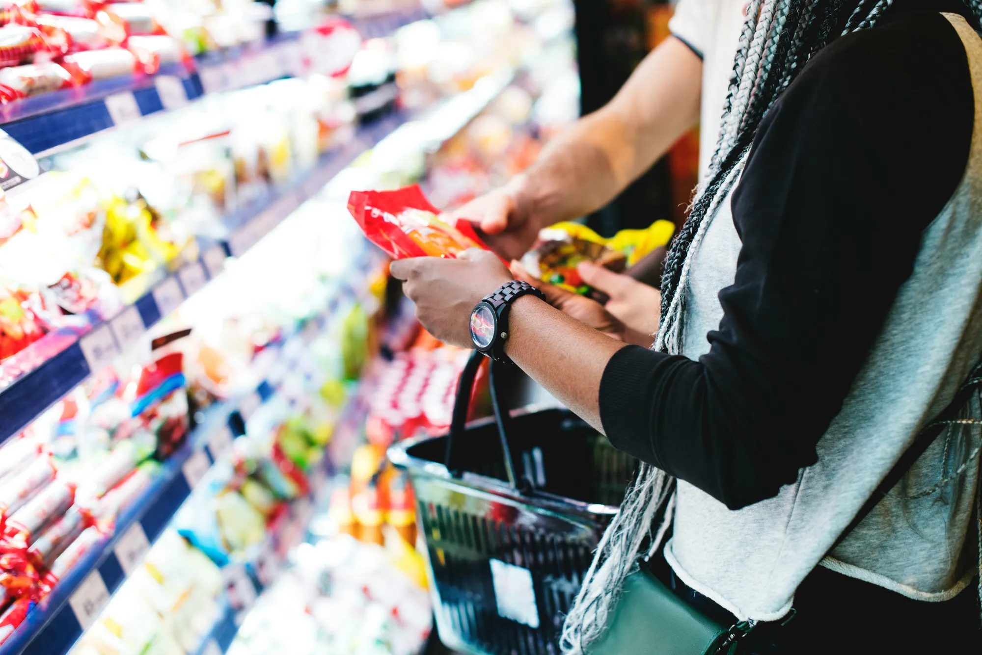 A shopper examining a product on a grocery shelf