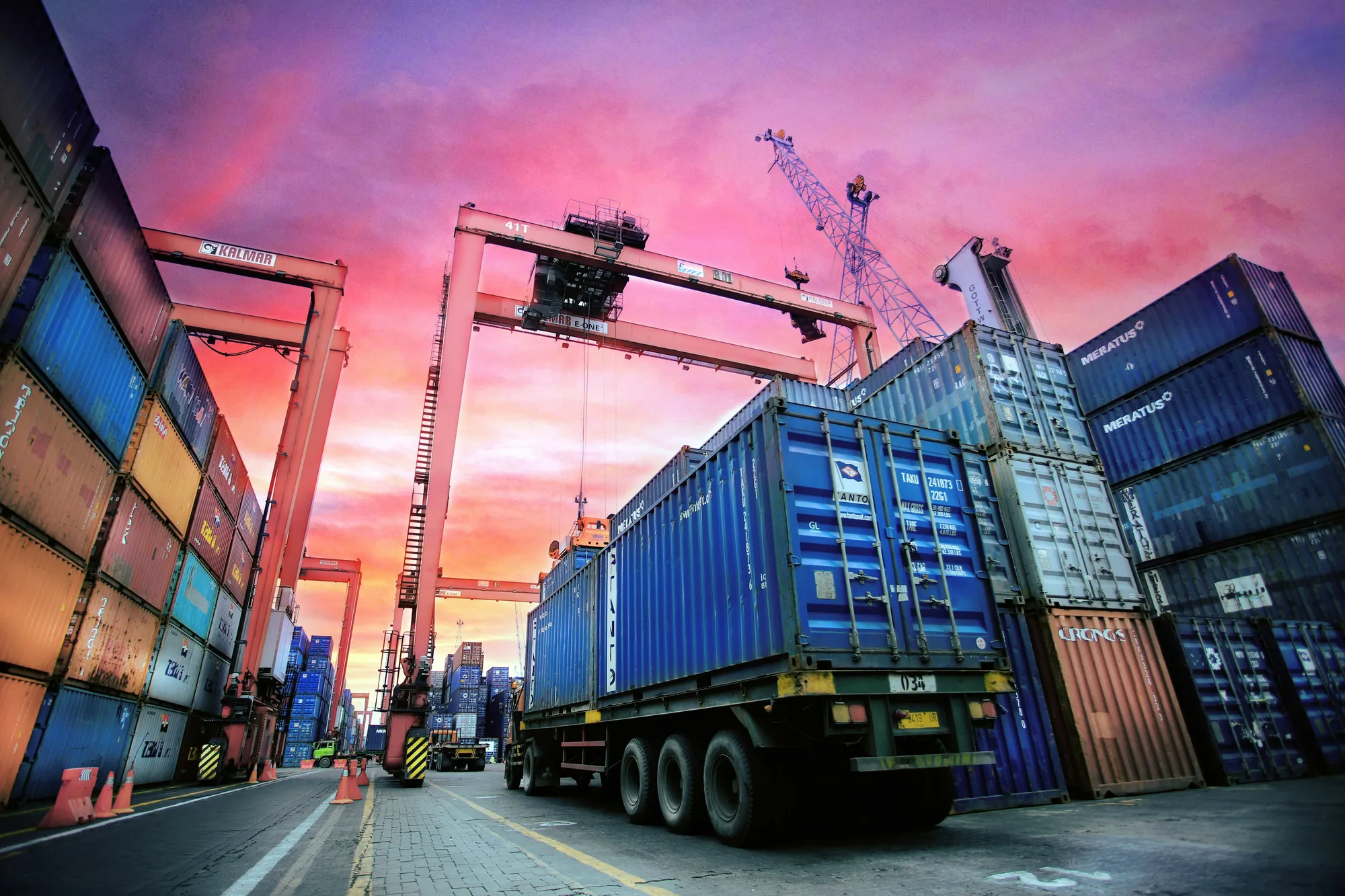 Container port at sunset with gantry cranes