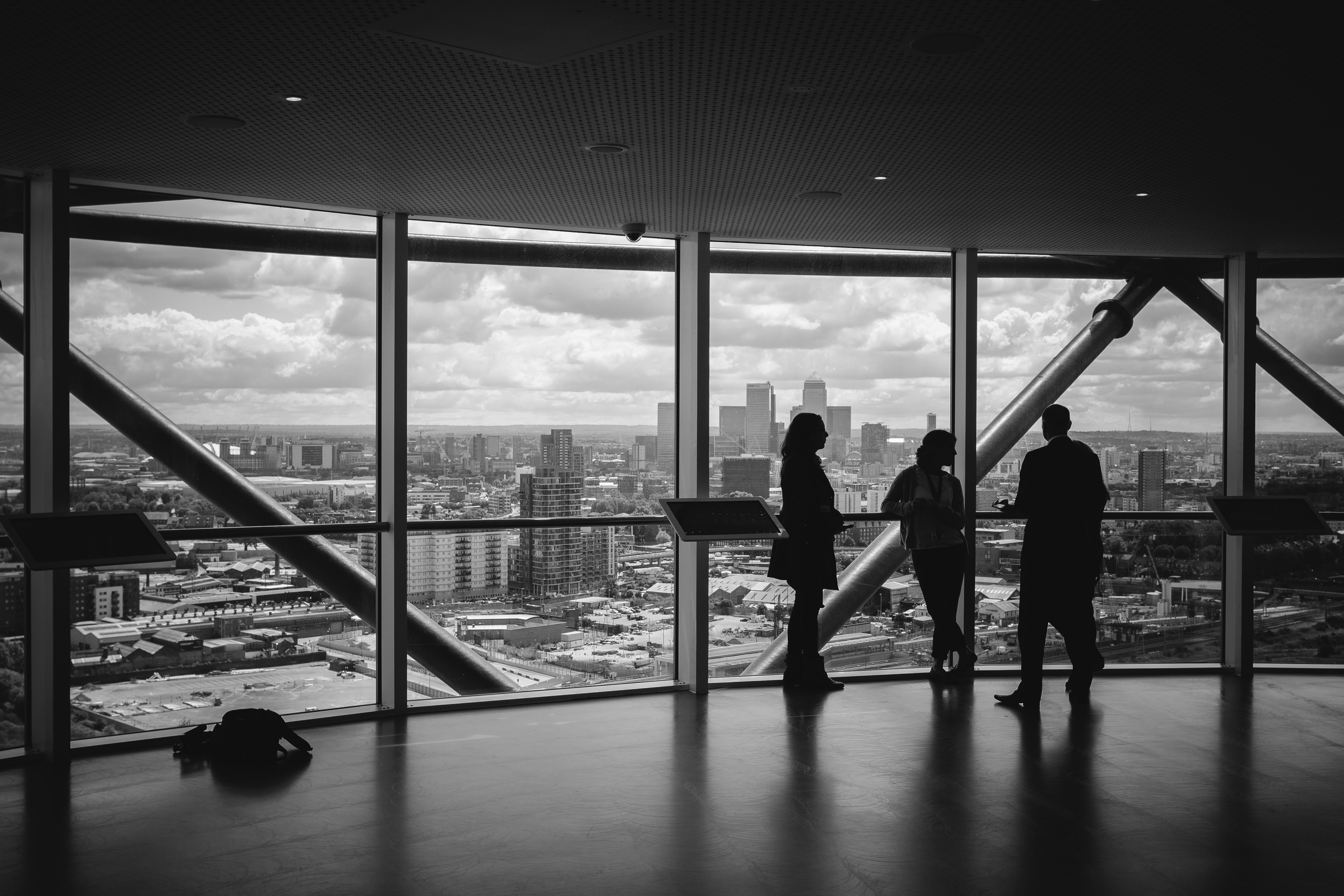Silhouettes of people looking out over a city skyline