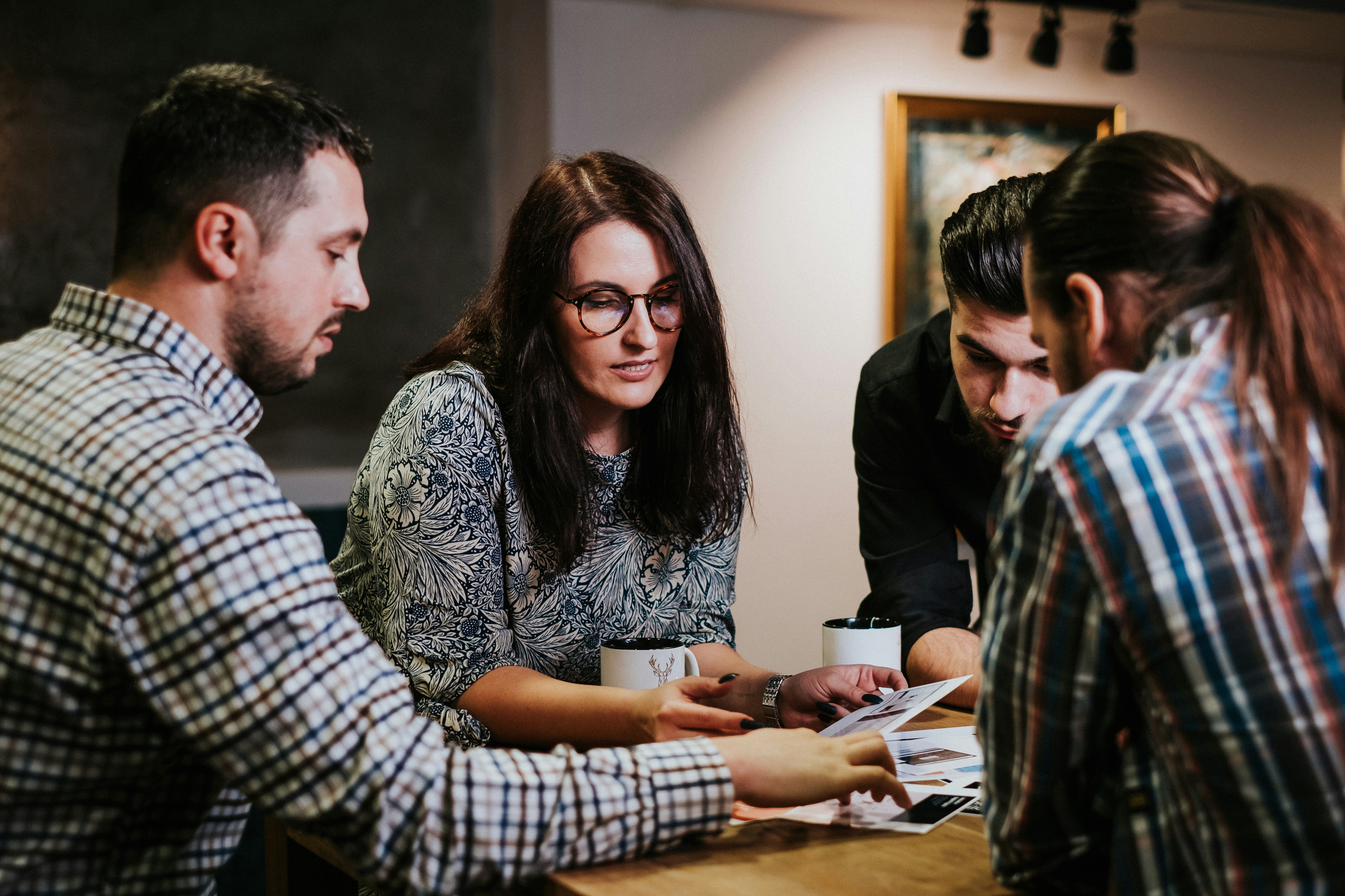 A small team reviewing documents together around a table
