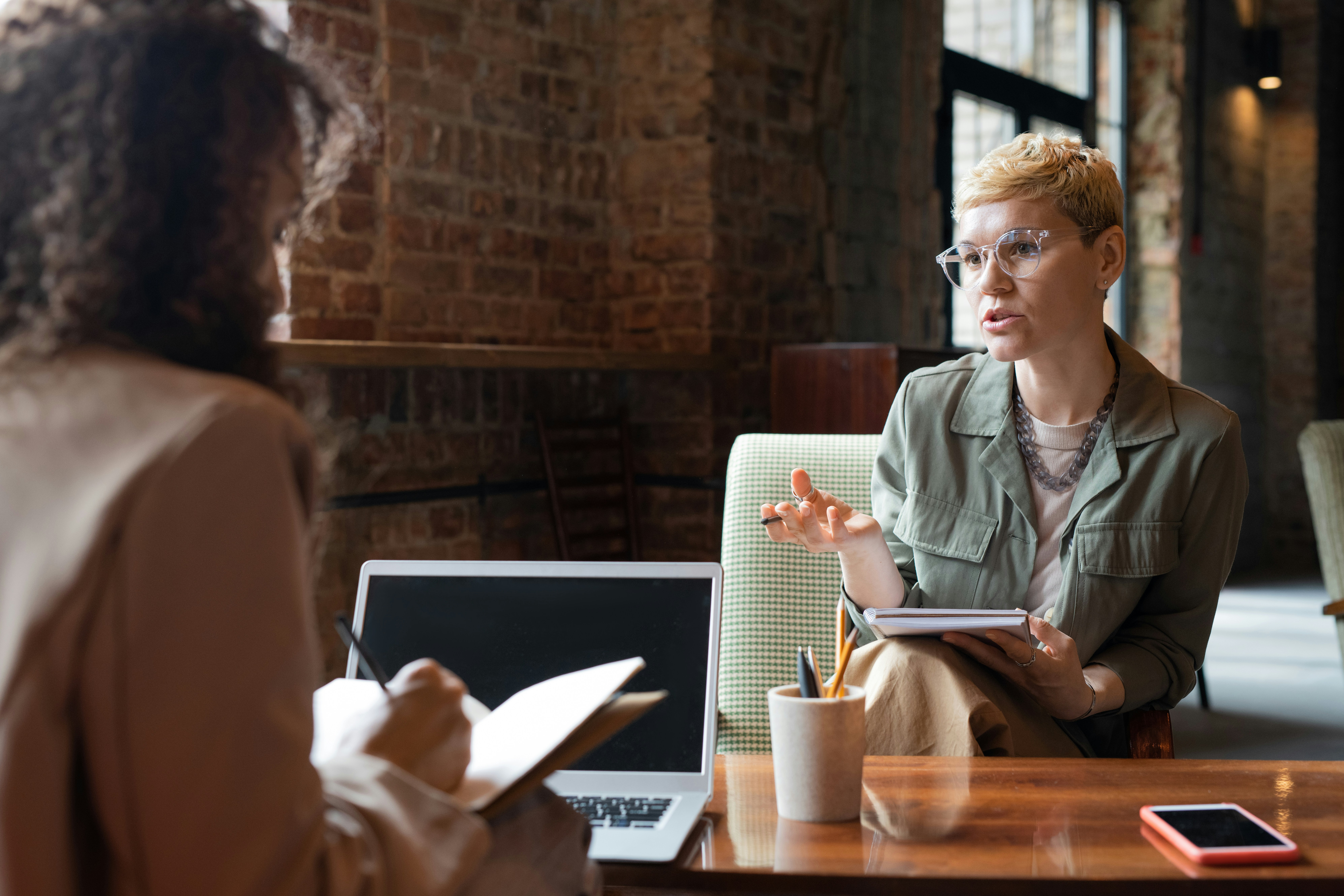 Two colleagues in a one-on-one meeting in a modern office